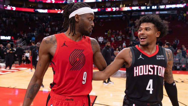 Trail Blazers forward Jerami Grant (9) hugs Houston Rockets guard Jalen Green (4) after their game at Toyota Center.